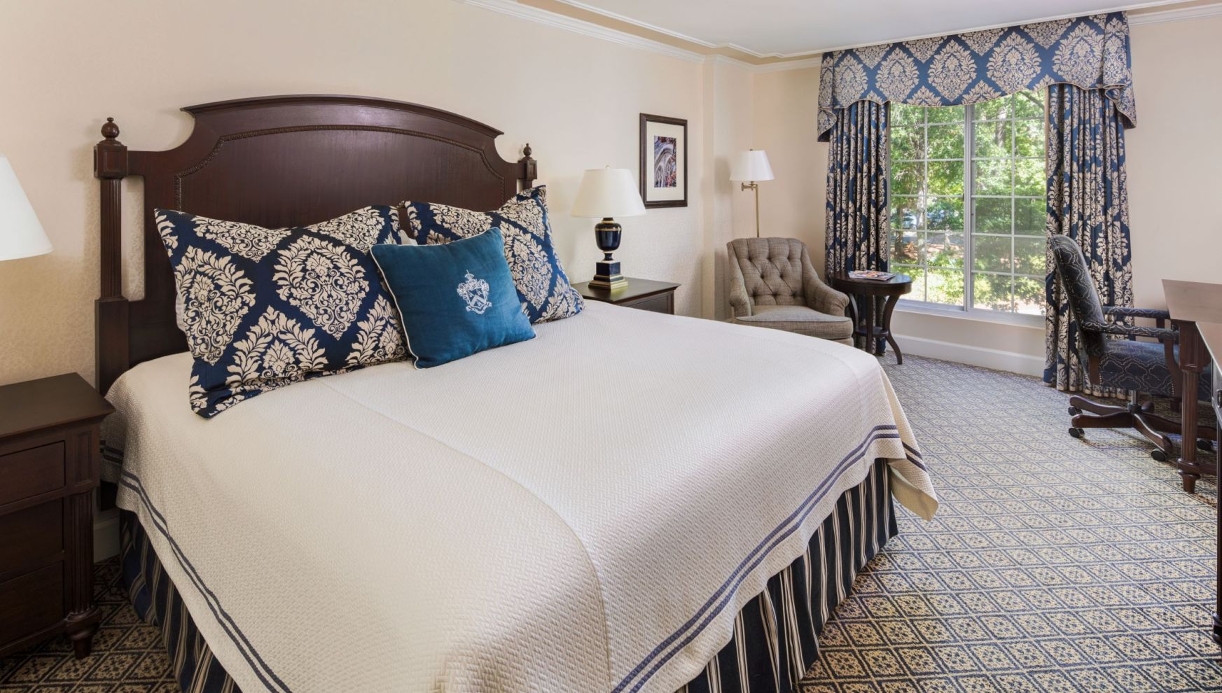 A Bed With Blue And White Pillows